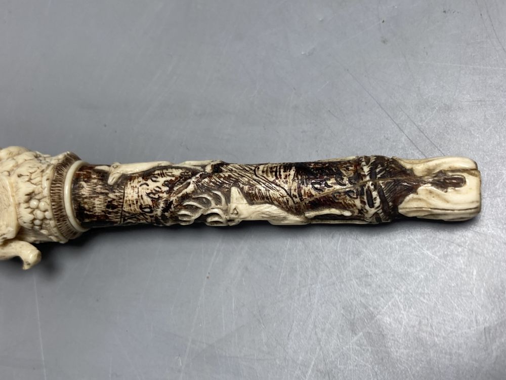 A Dieppe carved ivory pipe tamper, length 11cm